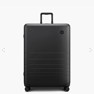 Monos large suitcase. Brand new. Still in the box. Never been used.